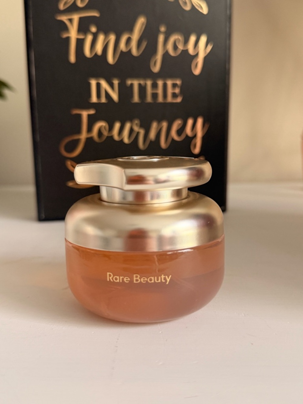 Rare Beauty peach and metallic gold jar
